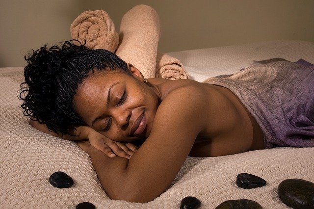 Black woman meditating in a spa