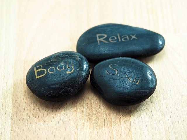 black stones with words of affirmations for black women on them