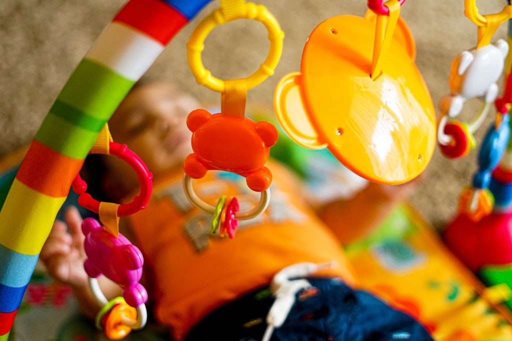 a baby playing with a play gym
