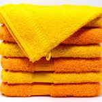 A stack of orange and yellow towels